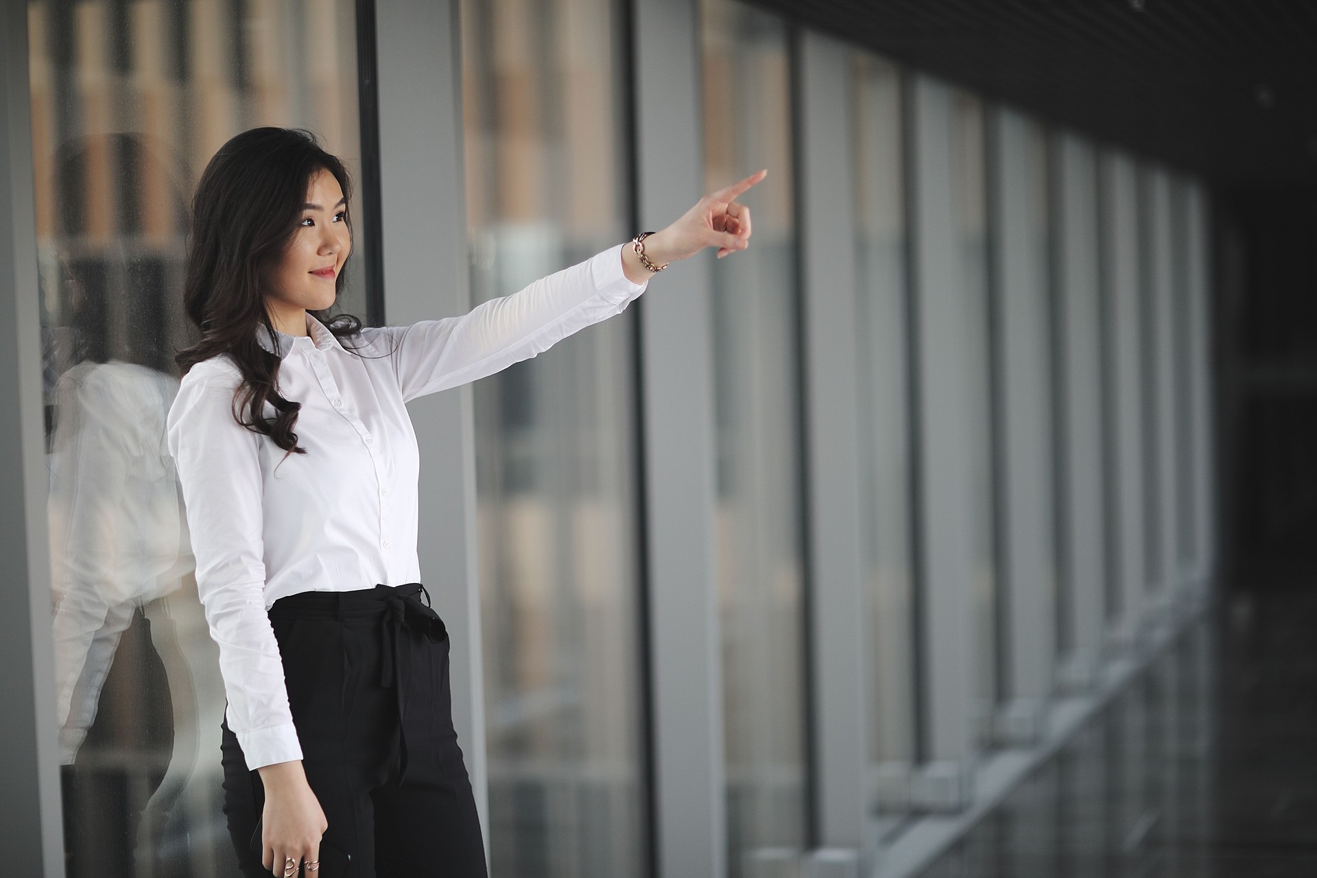 Young asian businesswoman pointing