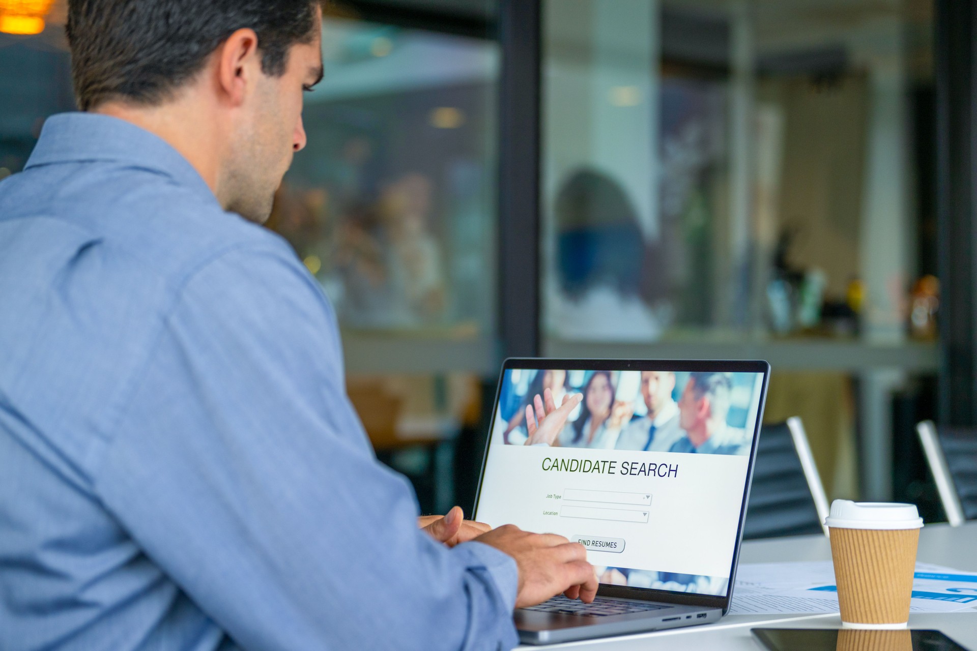 Businessman looking at recruitment website on a laptop computer.